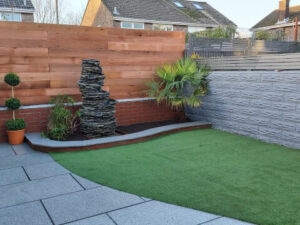 back garden with patio and artificial grass